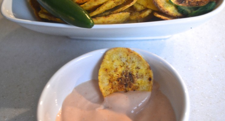 Spicy plantain chips dunked in salsa rosada.